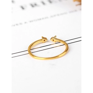 Macro detail of minimalist gold arrow open ring with sparkling white zircon stones