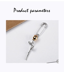 Detail of S925 silver rose safety pin earrings featuring gold and silver mixed tones