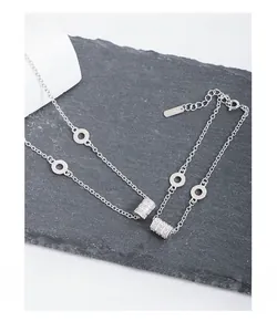 Detailed close-up of S925 sterling silver cylinder pendant with micro-set zircons