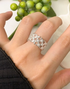 Close-up of S925 sterling silver lattice ring with pavé zircons on woman's hand
