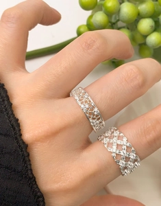 Close-up of S925 silver mesh lace rings with woven texture and small zircon accents