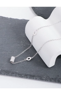 Macro shot of S925 sterling silver cylinder pendant with cubic zirconia on a necklace