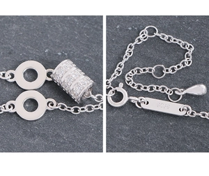 Macro detail of S925 sterling silver necklace showing pavé cylinder and spring clasp