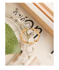 Vue macro détaillée d'une bague minimaliste dorée en forme de bambou avec fini poli