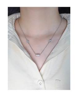 Detail of S925 silver waist necklace with zircon pendant worn by a model
