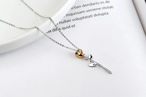 Macro shot of S925 sterling silver hallmark on golden rose flower pendant necklace