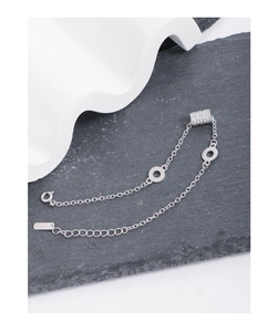 Detail shot of S925 sterling silver stamp on minimalist chain bracelet with zircon charm