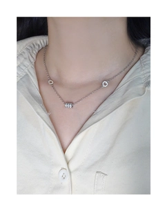 Detailed view of S925 sterling silver cylinder pendant necklace on a model's neck