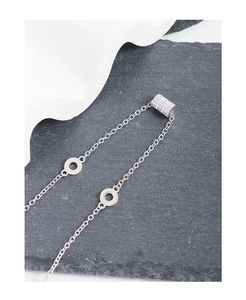 Macro shot of S925 sterling silver necklace with sparkling zircon cylinder charm detail