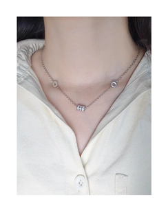 Detail of S925 sterling silver cylinder pendant with pavé crystals on a dainty chain