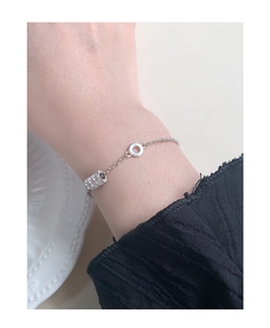 Close-up of S925 sterling silver bracelet featuring sparkling zircon cylinder pendant