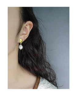 Close-up of S925 silver baroque pearl earring worn on model for minimalist style