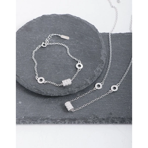 S925 sterling silver cylinder pendant necklace and bracelet set on grey stone base