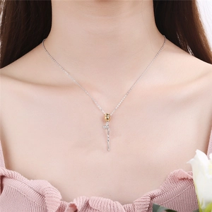 S925 silver necklace with golden rose pendant on a model's collarbone