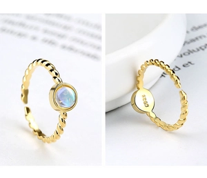 Detail of S925 sterling silver stamp and moonstone on twisted golden ring