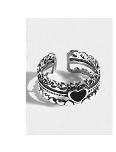 Detailed macro view of retro S925 sterling silver ring with black heart enamel element