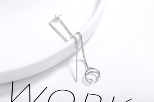 Detail of minimalist S925 sterling silver chain earrings with sleek ear bone clip
