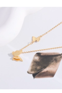 Detailed view of elegant gold butterfly pendant necklace with tiered metal layering