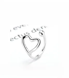 Macro shot of minimalist 925 silver ear cuff with smooth heart and bead details