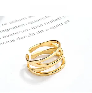 Macro view of adjustable three-layer gold streamlined ring with minimalist multi-band design