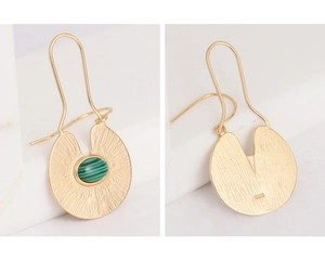 Macro view of gold S925 silver earrings with green malachite and brushed metal texture