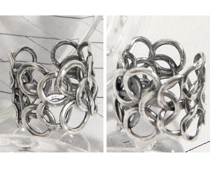 Macro shot of S925 sterling silver stamp on vintage intertwined chain link open ring
