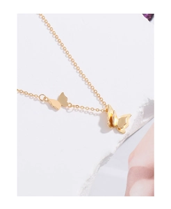 Detailed view of a golden butterfly pendant featuring a 3D double-layered wing design