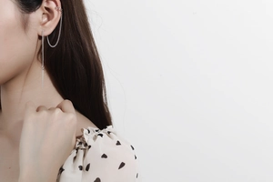 Detail of S925 sterling silver ear line and cuff on model with sleek link chain