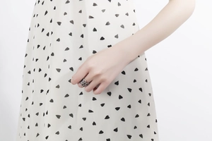 Detailed close-up of a silver intertwined hollow-out vintage ring worn by a model