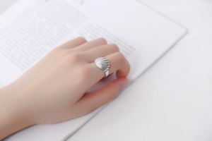 Detailed view of an S925 silver ring featuring an elegant shell-shaped fan design