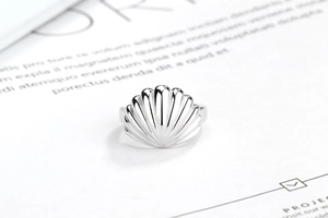 Macro detail of silver S925 shell ring with polished fan shape textures and minimal design