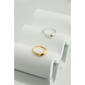 Detailed macro view of S925 sterling silver stamp on minimalist wave design rings