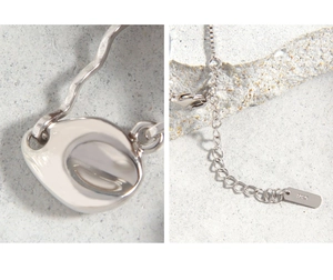 Macro shot of S925 sterling silver chain with lobster clasp and engraved hallmark tag