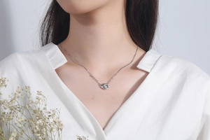 Polished S925 sterling silver geometric pendant necklace worn on neck with white shirt