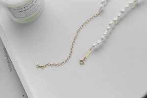 Detailed close-up of 925 sterling silver S925 hallmark clasp and baroque pearl necklace