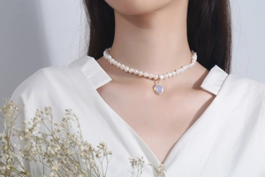 Detail of 925 silver baroque pearl necklace with moonstone charm on model's neck