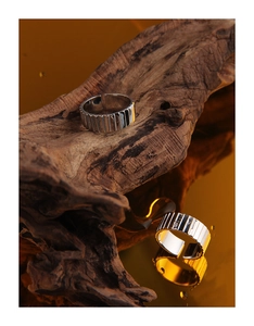 Detailed view of S925 silver adjustable rings with vertical gear textures on wood