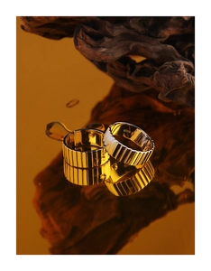Detailed close-up of S925 sterling silver stamp on golden textured minimalist ring