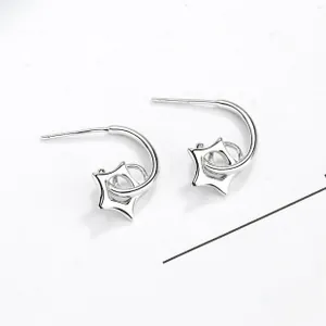 Macro shot of silver S925 sterling silver hoop earrings with hollow star pendant details