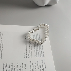 Macro detail of double-layer beaded ring with white pearls and silver metal beads