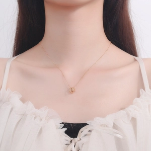 Elegant gold beaded chain necklace with interlocking twin circles and sparkling zircons