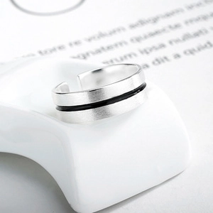 Detail of minimalist S925 silver ring featuring brushed texture and black inlay