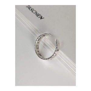Macro shot of 925 sterling silver ring with engraved star and moon patterns
