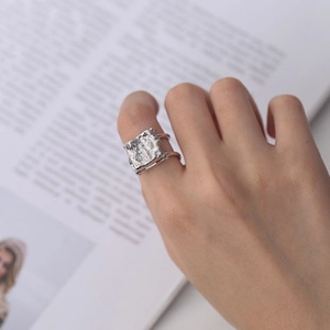 Close-up of S925 sterling silver ring with double band and hammered texture detail