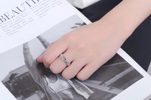 Close-up of double layer silver S925 sterling silver crossover ring on model hand