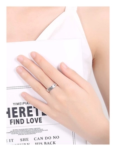 Detailed view of sterling silver ring featuring embossed star and moon pattern on finger