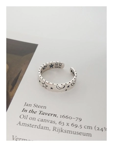 Close-up of S925 sterling silver ring featuring engraved star and moon motifs with hallmark