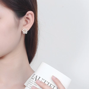 Elegant floral pearl stud earrings for women shown on model for a minimalist style