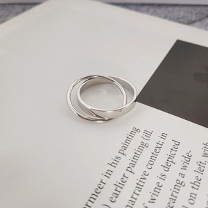 Close-up of interlocking S925 sterling silver double ring with polished finish