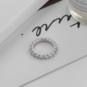 Macro shot of silver sterling gear eternity ring with sparkling cubic zirconia pavé setting